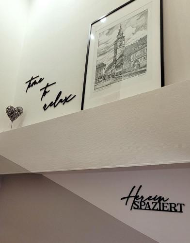 a shelf in a room with a picture on it at Am Kornmarkt in Bad Langensalza
