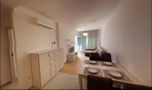a living room with a kitchen and a living room with a couch at Apartment WaveSea in Becici