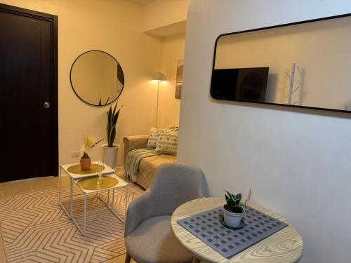 a living room with a chair and a mirror at Reign Escape in Manila