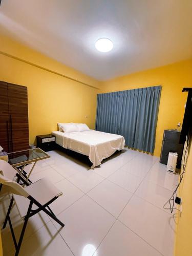 a bedroom with a bed and a table and chairs at Ｍing Shu Min Su in Linyuan