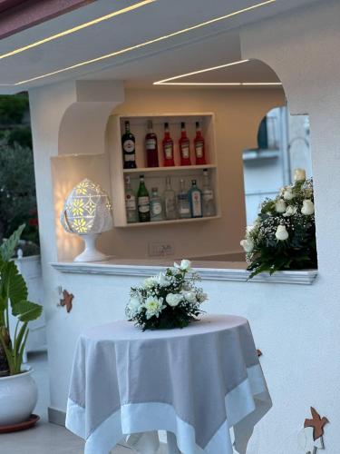 a table with flowers on it in front of a refrigerator at Minori Palace in Minori