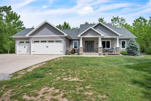 a house with a garage at Lakeside Retreat with Hot Tub & Game Room home in Elkhart