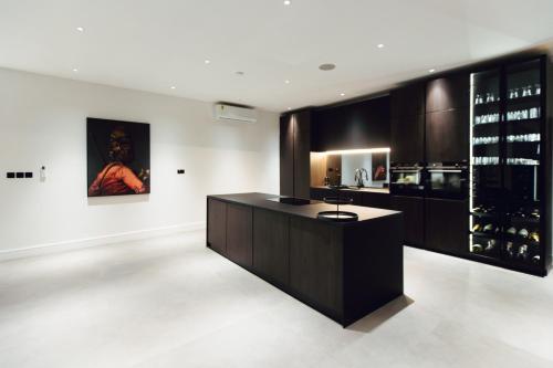 a wine tasting room with a counter and a painting at The VVS Apartments in Accra