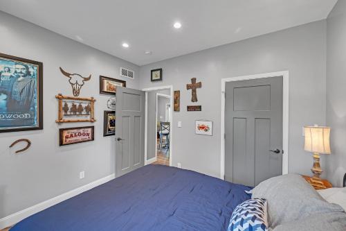 a bedroom with a blue bed and some pictures on the wall at Lakeside Retreat with Hot Tub & Game Room home in Elkhart