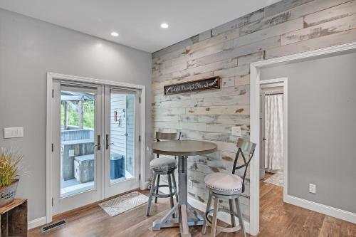 a dining room with a table and two stools at Lakeside Retreat with Hot Tub & Game Room home in Elkhart