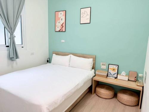 a bedroom with a bed and a nightstand with a bed sidx sidx at Good Stay in Tainan