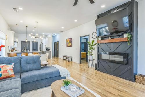 a living room with a blue couch and a fireplace at Stylish Bungalow Near BeltLine & Breweries bungalow in Atlanta