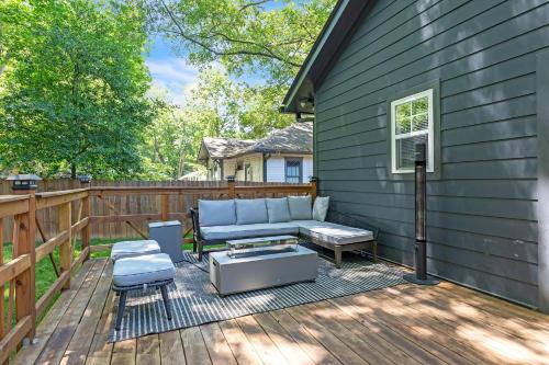 a patio with a couch and a table at Stylish Bungalow Near BeltLine & Breweries bungalow in Atlanta