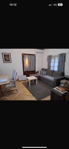 a living room with a couch and a table at Kuća za odmor Tupek in Zagreb
