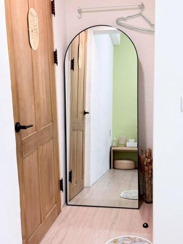 a hallway with a mirror in a room at Good Stay in Tainan