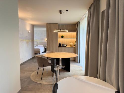 a room with a table and chairs and a bedroom at Miramontino Mountain Suite in Rota d'Imagna