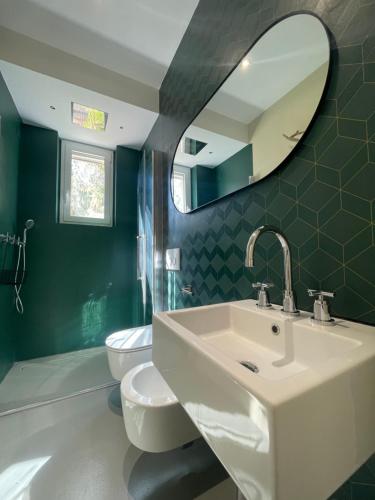 a bathroom with a sink and a toilet and a mirror at Monte Pino in Pergola