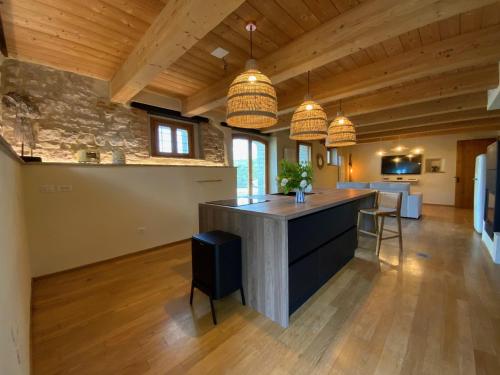 a kitchen with a island in the middle of a room at Monte Pino in Pergola