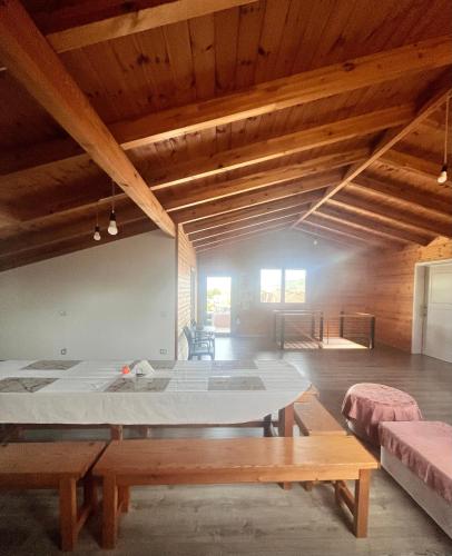 a large room with a large bed and a table at Wooden Guest House in Bamatat