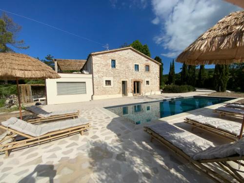 a villa with a swimming pool and a house at Monte Pino in Pergola