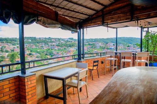 a bar with tables and chairs on a balcony at QUALITY INN HOTEL Kigali in Kigali