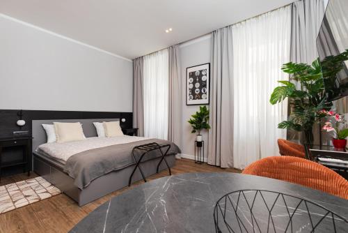 a bedroom with a bed and a glass table at Sir John's Apartments in Rijeka