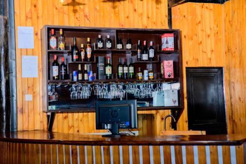 a bar with a lot of bottles of alcohol at QUALITY INN HOTEL Kigali in Kigali