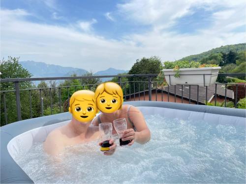 two people in a jacuzzi in a hot tub at Zen Retreat - Spa in Nature Serenity in Arosio