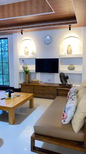 a living room with a couch and a table at Villa Padi Pakem in Pakem