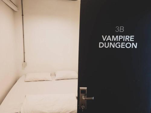 a black door with a bed in a room at HOLY SHEET Hostel in Bangkok