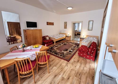 a living room with a table and chairs and a living room at Apartment in a historical house in the center of Levoča in Levoča