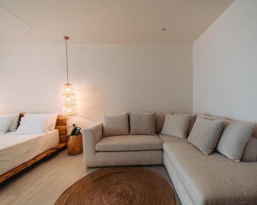 a living room with a couch and a bed at Elar Hotel in Sarandë