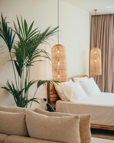 a bedroom with a bed and a potted plant at Elar Hotel in Sarandë