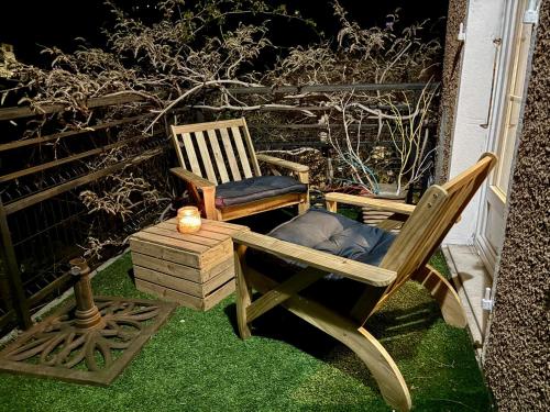 two chairs sitting on the grass on a patio at Les Capucines, comme chez soi, loin de chez soi in Aubenas