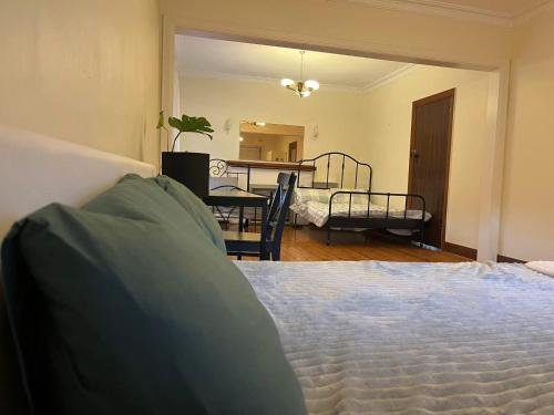 a bedroom with a bed and a dining room at Free Parking 5min Walk to Asian Supermarket Family Room Deakin Uni Quiet Camberwell in Camberwell