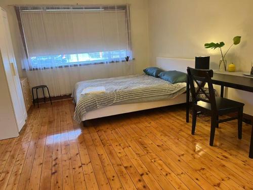 a bedroom with a bed and a wooden floor at Free Parking 5min Walk to Asian Supermarket Family Room Deakin Uni Quiet Camberwell in Camberwell
