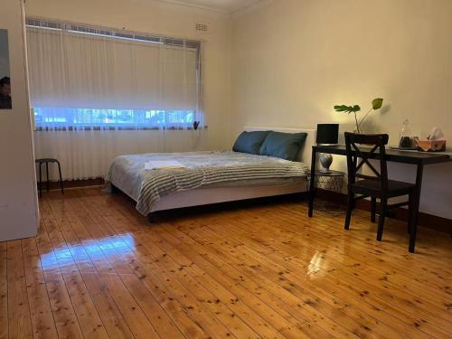 a bedroom with a bed and a desk and a table at Free Parking 5min Walk to Asian Supermarket Family Room Deakin Uni Quiet Camberwell in Camberwell
