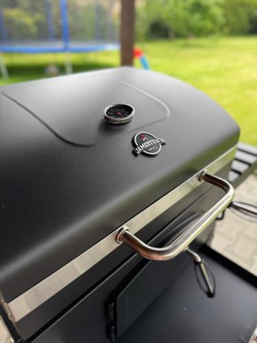 a close up of a grill with two pins on it at Entire 2nd floor of Villa with 3bedroom with large garden,BBQ,pool,sauna,free parking in Popovičky