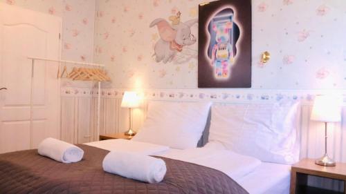 a bedroom with a bed with two pillows on it at Entire 2nd floor of Villa with 3bedroom with large garden,BBQ,pool,sauna,free parking in Popovičky