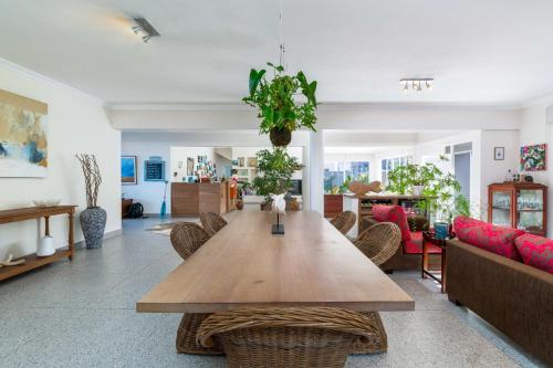 a living room with a wooden table and chairs at Dune Beach House in Wilderness