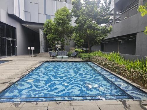 a swimming pool in front of a building at Star Residence KLCC By Cozy in Kuala Lumpur