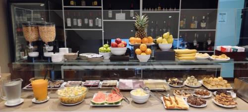 a display case filled with different types of food at Altos De Merlo Suites in Merlo