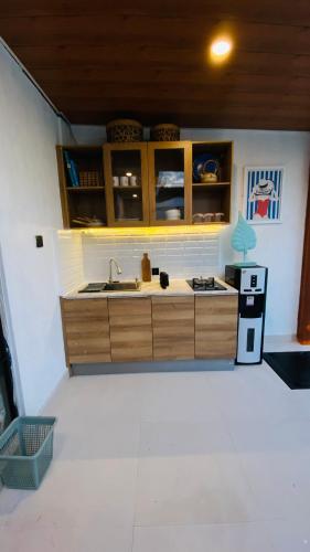 a kitchen with a sink and a refrigerator at Villa Padi Pakem in Pakem