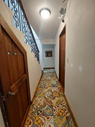 a hallway with a colorful tile floor in a house at Hotel Campestre Ronda Ecuestre Rionegro in La Ceja