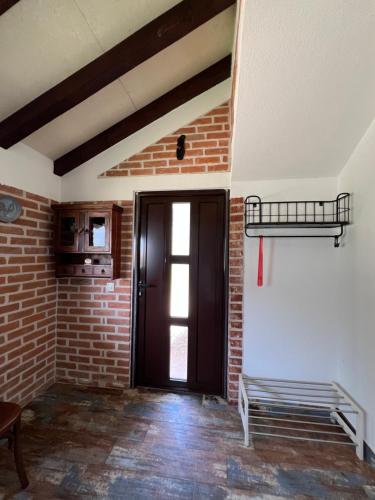 a room with a brick wall and a door at Villa SHU in Krimovice