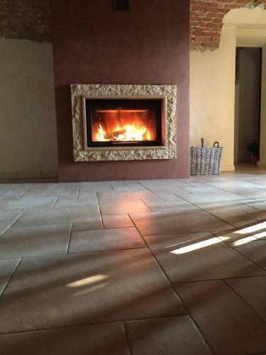 a living room with a fireplace in the wall at Myricae in Farigliano