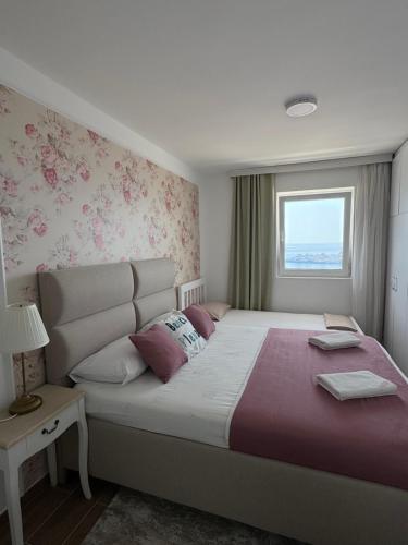 Un dormitorio con una cama grande y una ventana. en Pine&Sea Beach Retreat, en Sveti Stefan