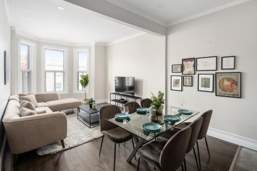 a living room with a table and a couch at The Parc Mile End ApartHotel in Montréal