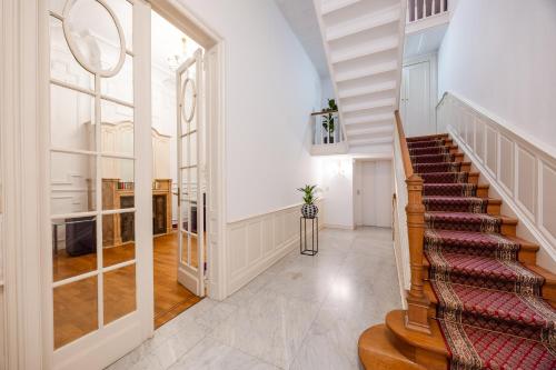 a hallway with a staircase in a house at Viktoria B & B in Brussels