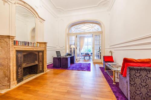 an ornate living room with a fireplace and a couch at Viktoria B & B in Brussels
