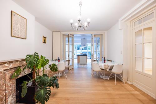 a living room with a table and chairs and a fireplace at Viktoria B & B in Brussels