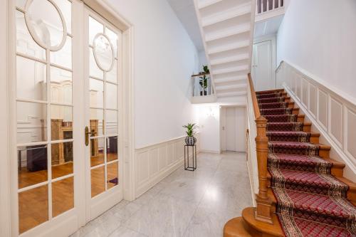 a hallway with a staircase in a house at Viktoria B & B in Brussels