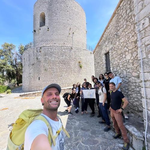 a group of people standing in front of a castle at LIMO to Host in Roccaromana