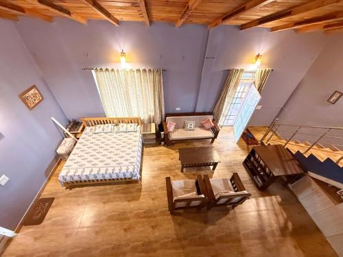 an overhead view of a living room with furniture at Cannery Row Chalet in Mukteswar