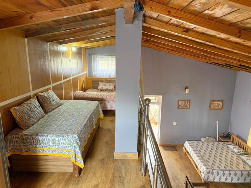 a bedroom with two beds and a mirror at Cannery Row Chalet in Mukteswar